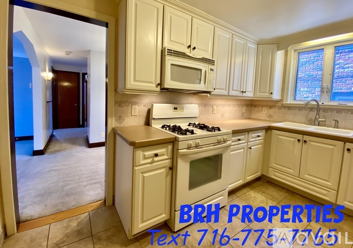 A kitchen with a stove, microwave, and cabinets is shown with the text "BRH PROPERTIES" and a phone number.