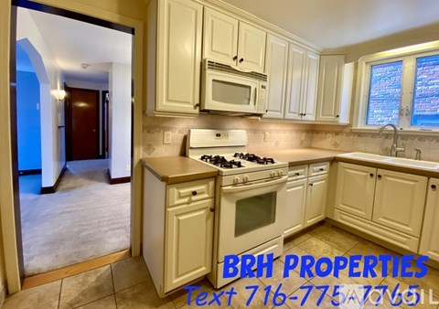 A kitchen with a stove, microwave, and cabinets is shown with the text "BRH PROPERTIES" and a phone number.
