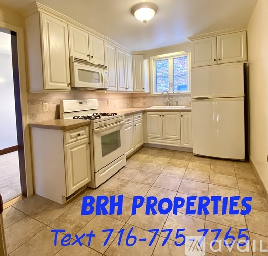 A kitchen with the text BRH PROPERTIES on the floor.