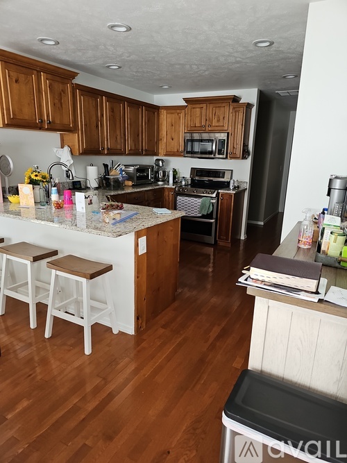 A kitchen with wooden cabinets and a white island.
