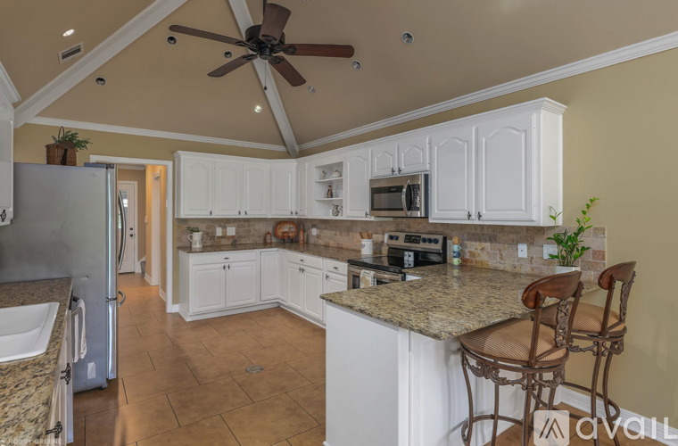 A kitchen with a refrigerator, sink, and countertop.