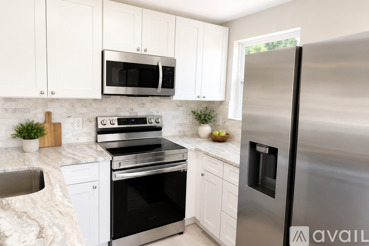 A kitchen with white cabinets and stainless steel appliances.
