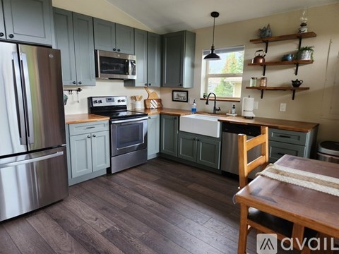 A kitchen with wooden floors and a wooden table.