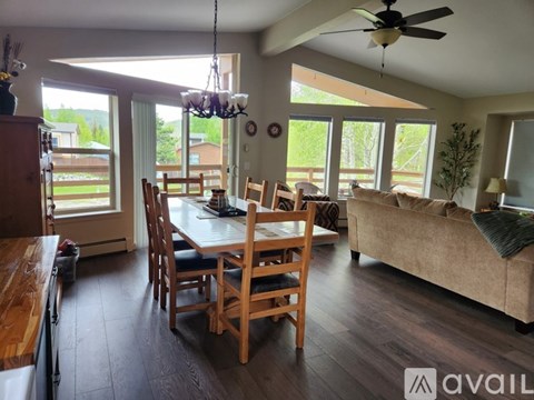 A living room with a dining table and chairs.