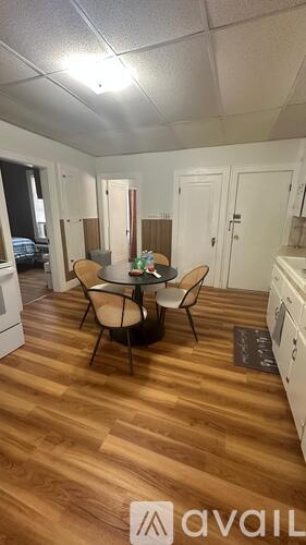 A kitchen with a table and chairs in the middle of the room.