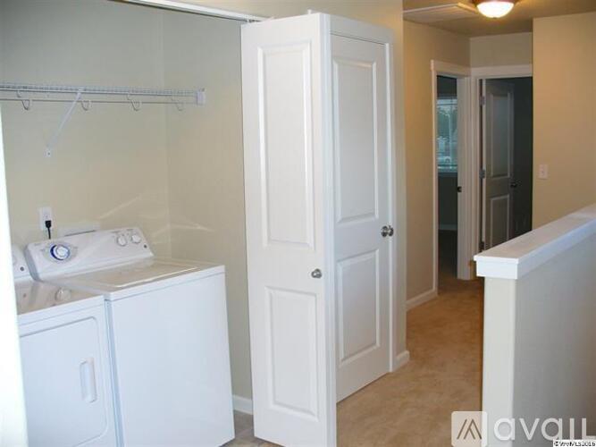 A white bathroom with a washer and dryer.