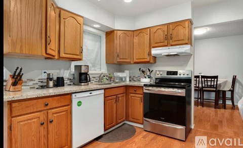 A kitchen with wooden cabinets and a stainless steel oven.
