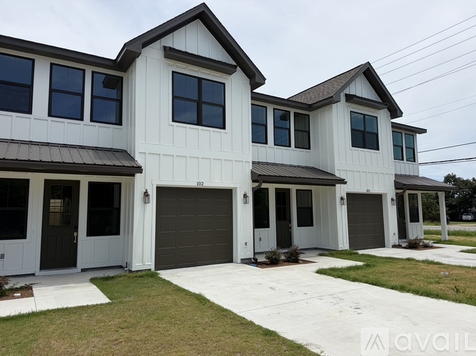 A two-story house with a garage is available for purchase.