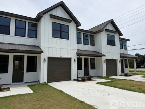 A two-story house with a garage is available for purchase.
