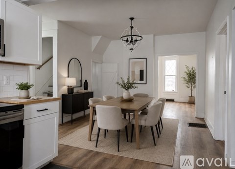 A modern kitchen with a dining table set for four.