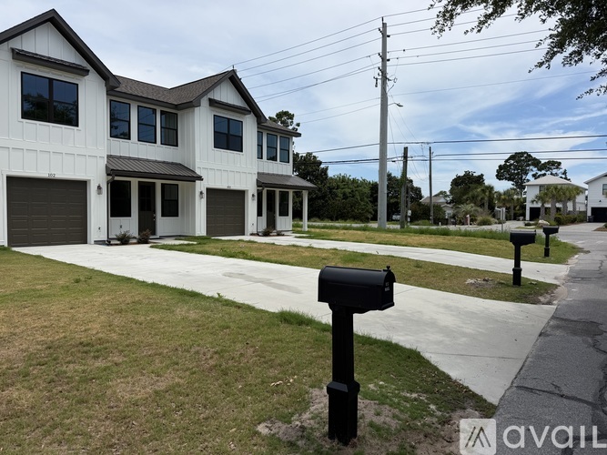 A row of houses with a black mailbox in front.