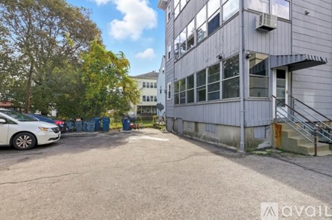 A parking lot with a car and a building in the background.