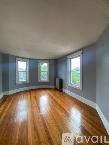 A room with wooden floors and a window.