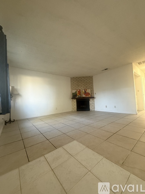 A living room with a fireplace and a television.