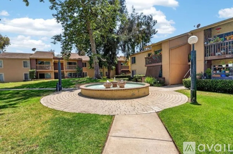 A courtyard with a fountain surrounded by apartment buildings.