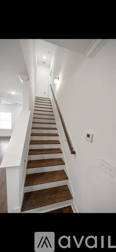 A staircase with wooden steps and white railings.