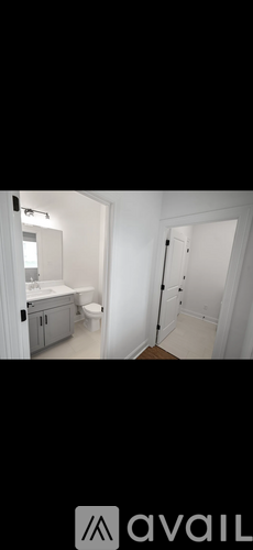 A bathroom with a toilet, sink, and bathtub.