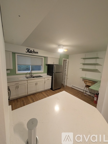 A kitchen area with a counter and a sink.