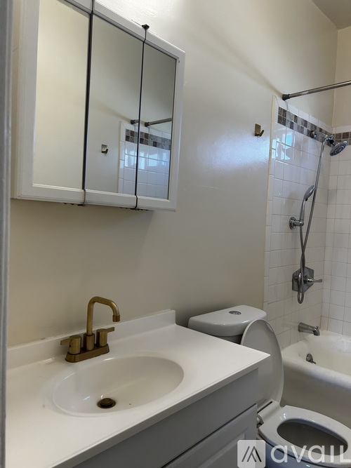 A white bathroom with a sink, toilet, and bathtub.