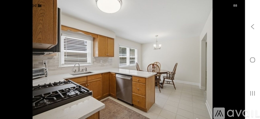 A kitchen with wooden cabinets and a white countertop.