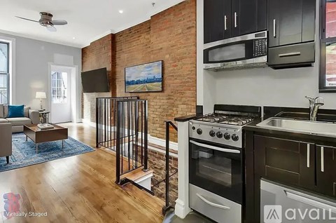 A kitchen with a brick wall and a stove top oven.