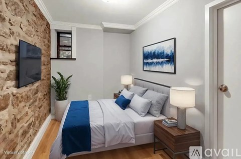 A bedroom with a stone wall and a bed with blue and white bedding.