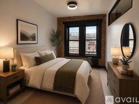 A bedroom with a large bed, a window with a view, and a lamp on the nightstand.