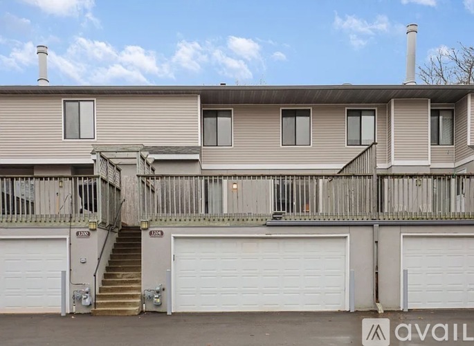 A two-story building with a balcony and a staircase leading to the second floor.