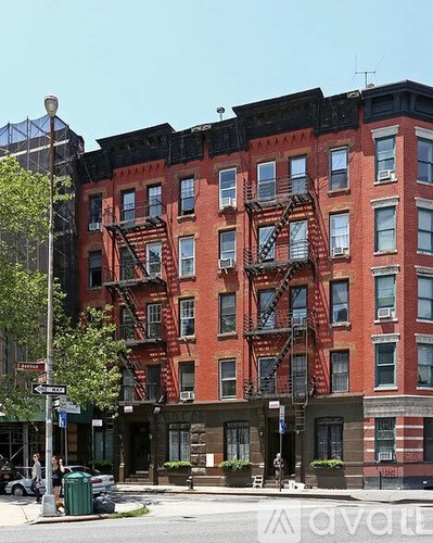 A red brick building with a fire escape on the side.