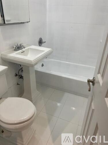 A white toilet and sink in a bathroom.