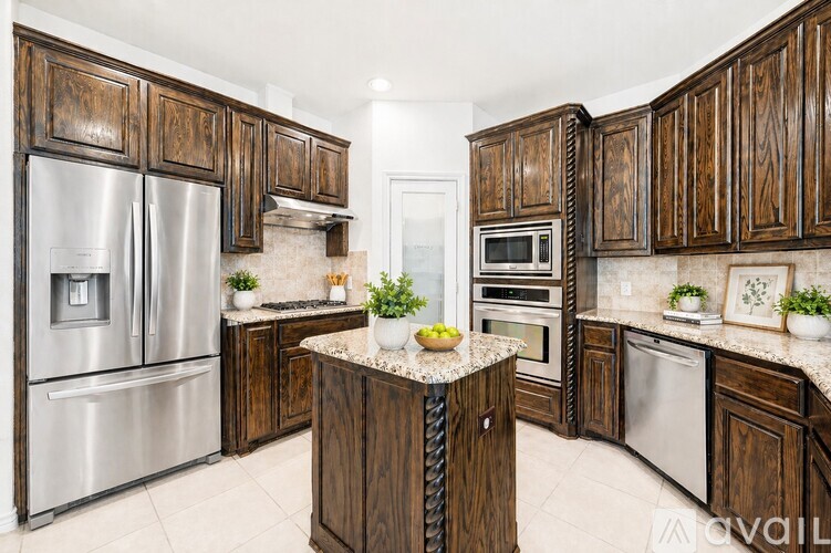 A kitchen with wooden cabinets and stainless steel appliances.