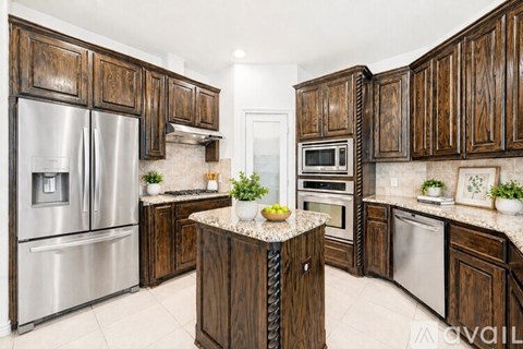 A kitchen with wooden cabinets and stainless steel appliances.