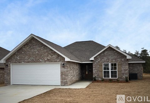 A house with a garage and a driveway is available for sale.