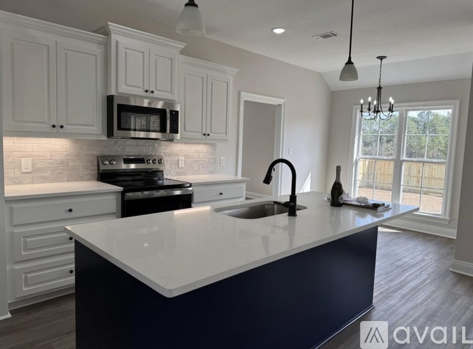 A kitchen with a white countertop and a black stove.