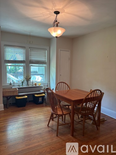 A dining room with a table and chairs.