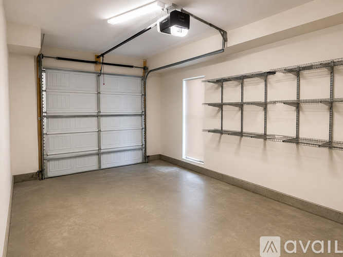 A spacious garage with a closed white door and a metal shelving unit on the wall.