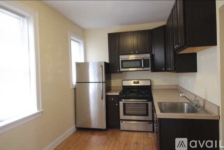 A kitchen with a stainless steel refrigerator, oven, and microwave.