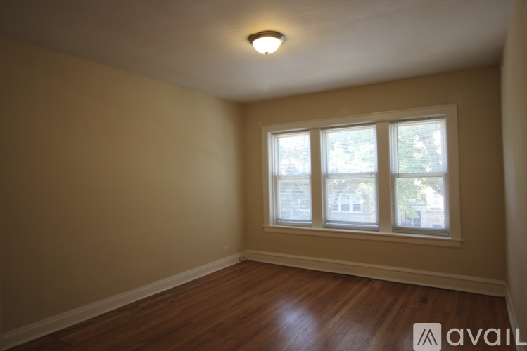 A room with a window and wooden floors.