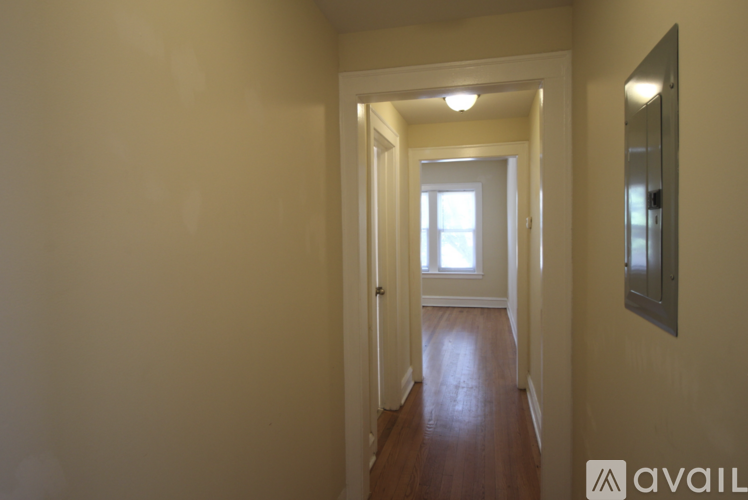 A hallway with a door at the end.
