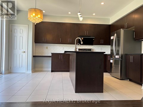 A modern kitchen with dark brown cabinets and a white countertop.