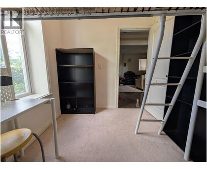 A room with a ladder and a desk.