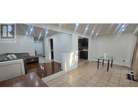 A spacious living room with a glass table and a couch.