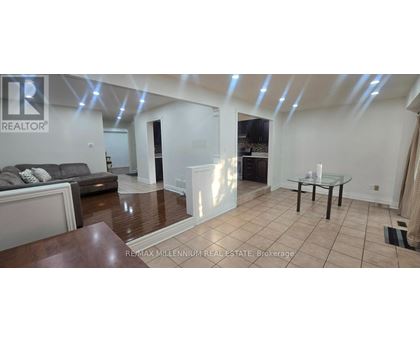 A spacious living room with a glass table and a couch.
