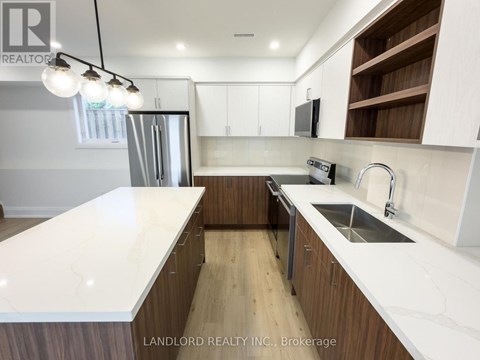 A modern kitchen with wooden cabinets and a white countertop.