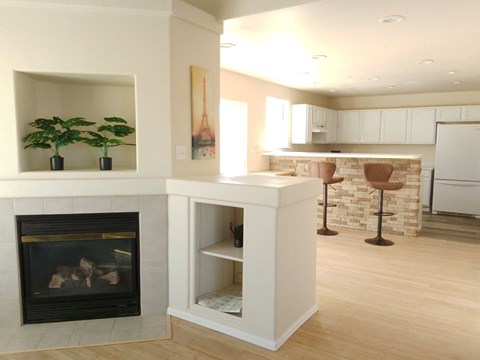 A white fireplace with a black grate and a white mantle.