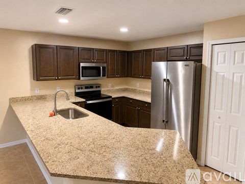 A kitchen with granite countertops and stainless steel appliances.