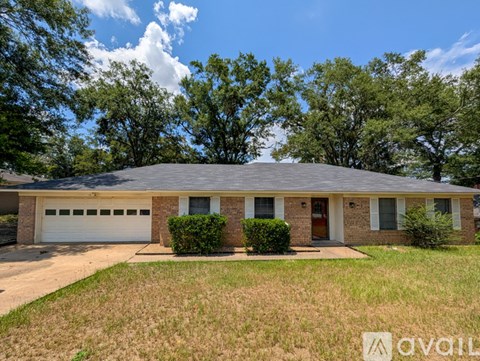 A house with a garage and a driveway is for sale.