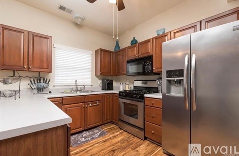 A kitchen with wooden cabinets and stainless steel appliances.