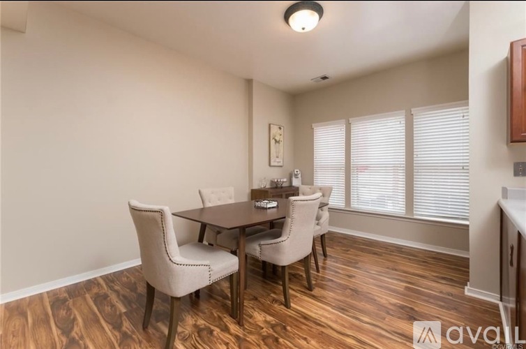 A dining room with a wooden table and chairs.