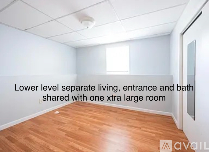 A room with wooden flooring and a text overlay describing the space.